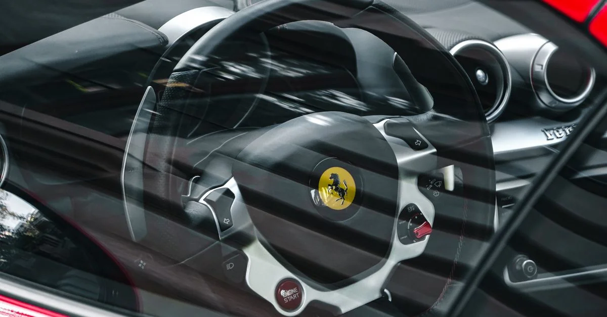 Gros plan sur l'intérieur d'une voiture de sport luxe montrant le volant à travers la fenêtre.